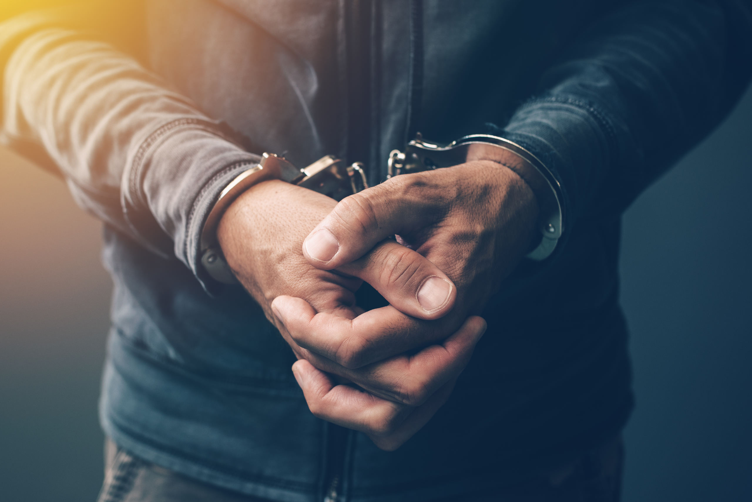 arrested-computer-hacker-with-handcuffs-PHVELVW