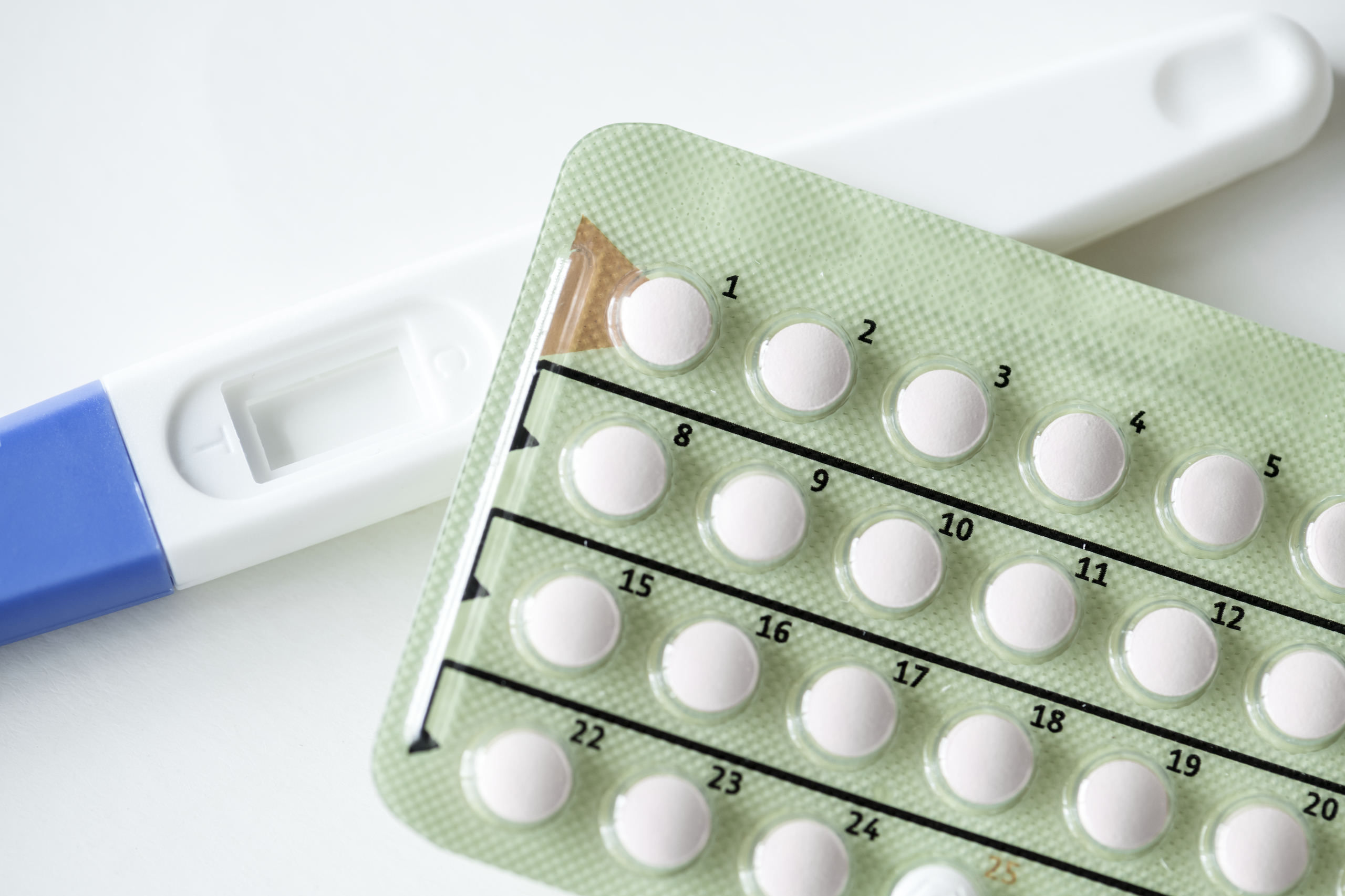 closeup-of-pregnancy-test-and-contraceptive-pills-PKZ2WEB