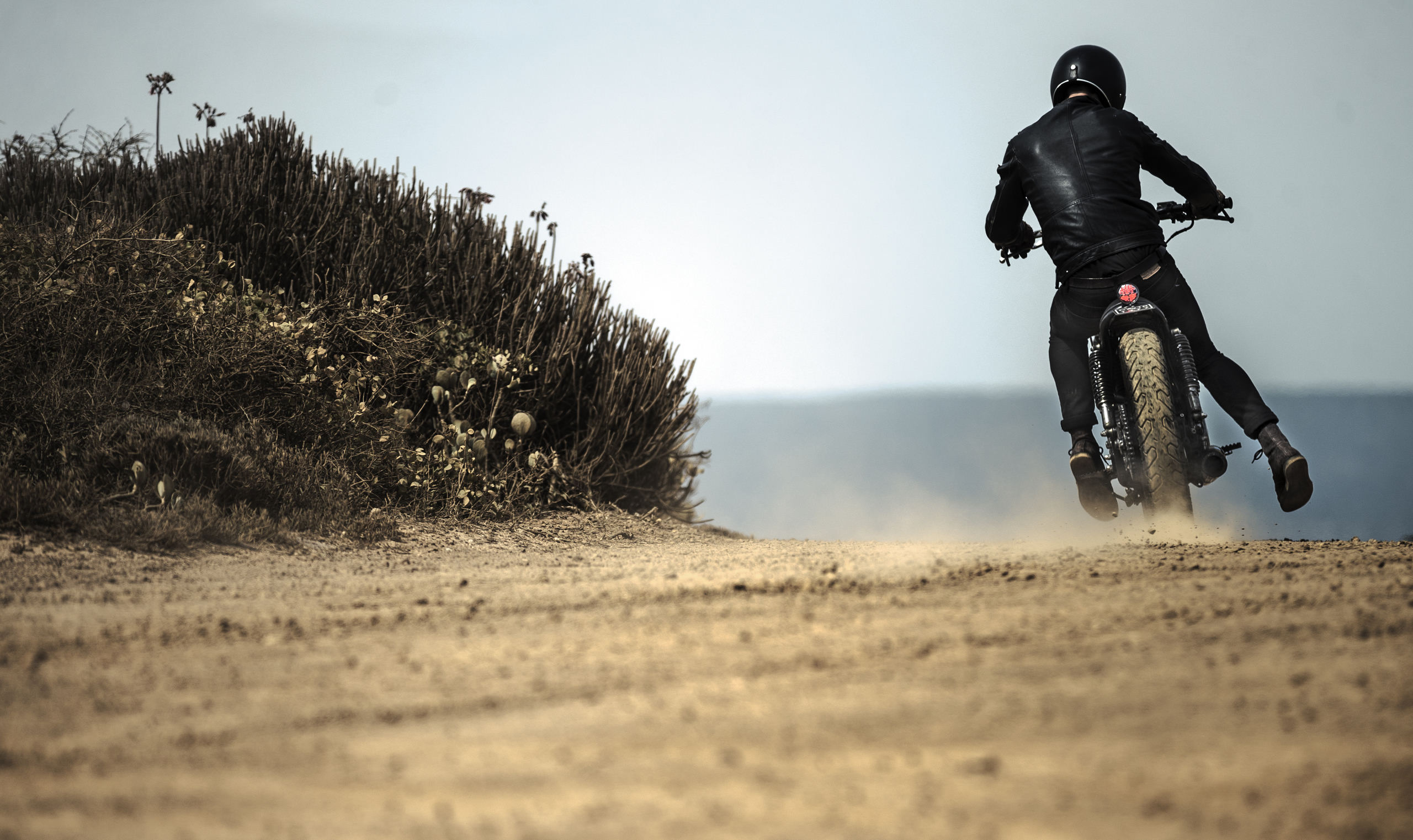 rear-view-of-man-wearing-crash-helmet-and-black
