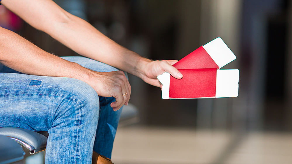 closeup-passports-and-boarding-pass-at-airport-ind-EVCJ3LW