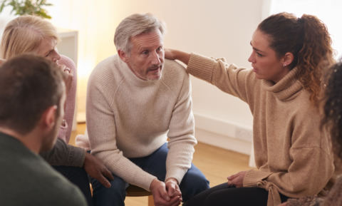 group-consoling-man-speaking-at-support-group-meet